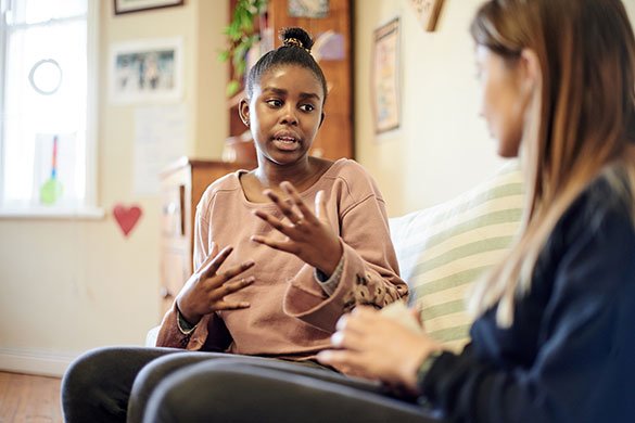 teen girl and counselor talking